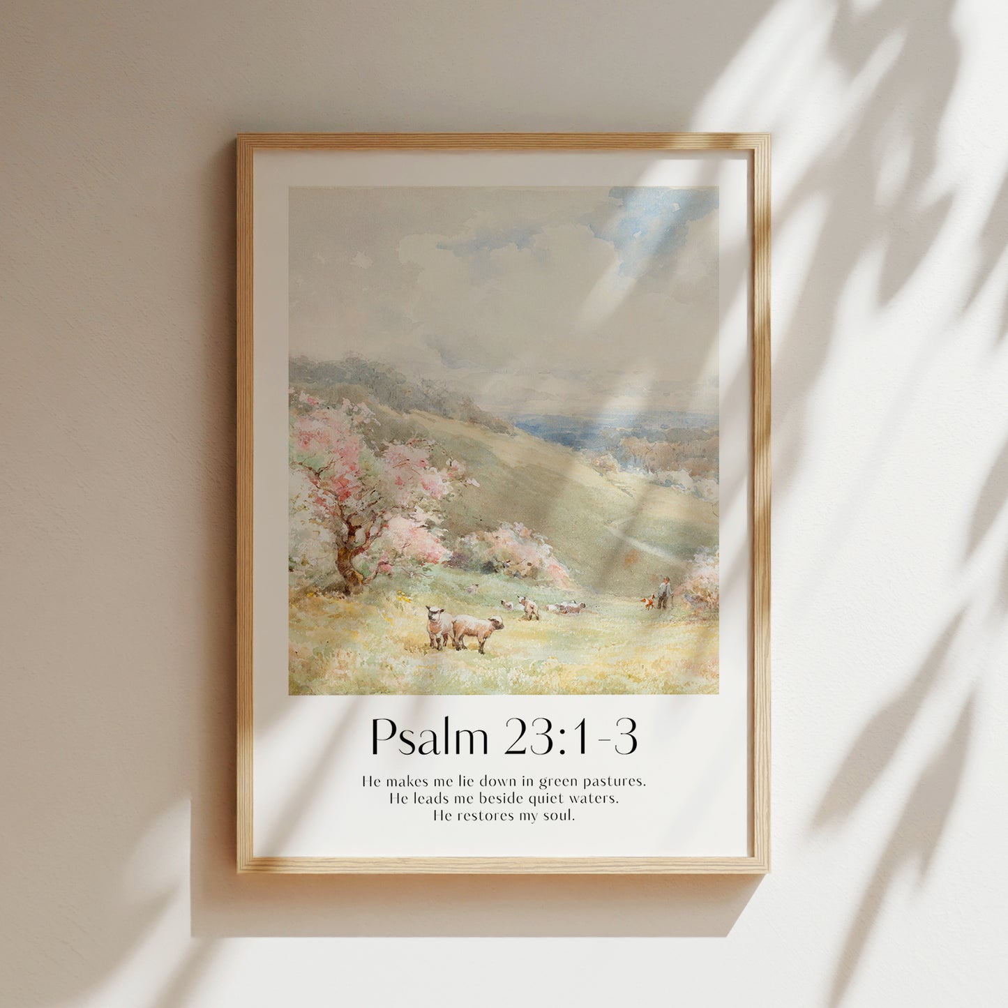 A framed Christian Print on a wall with sheep landscape and the bible verse Psalm 23