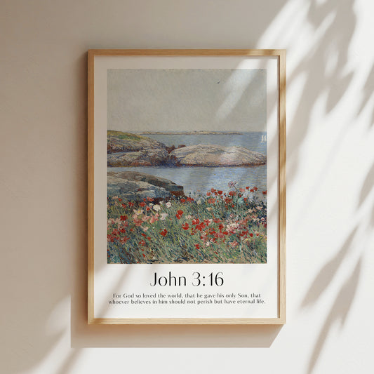 A framed Christian Print hanging in a room with a vintage seascape and the bible verse John 3:16