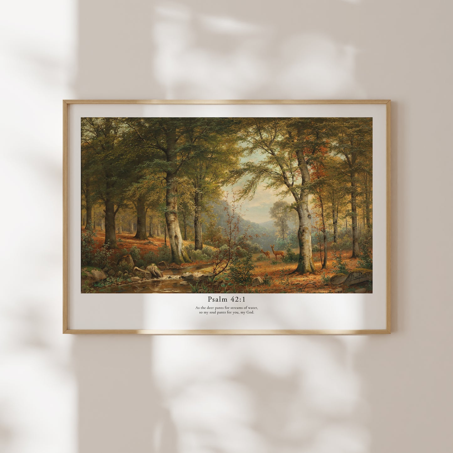 Framed artwork of a forest scene with Psalm 42:1 text on a wall.