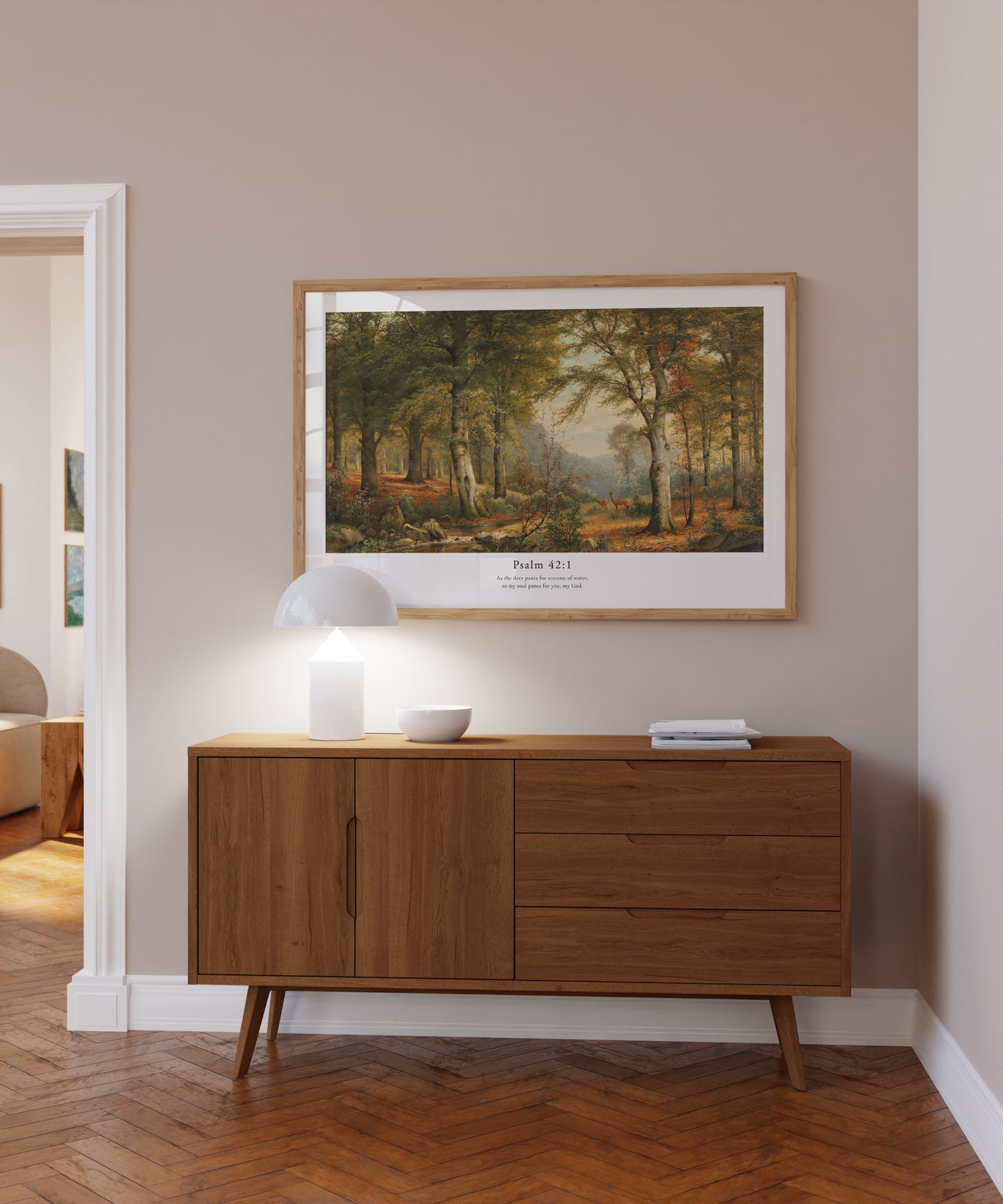 Wooden sideboard in a room with a framed landscape painting on the wall.