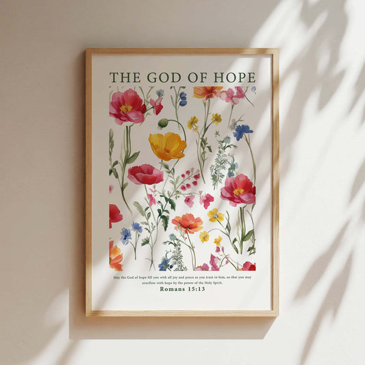 Framed Christian wall art print featuring a beautiful botanical illustration with vibrant flowers. The artwork is paired with the Bible verse from Romans 15:13: "May the God of hope fill you with all joy and peace as you trust in him, so that you may overflow with hope by the power of the Holy Spirit." This piece combines nature's beauty with an uplifting message, making it a perfect addition to any home or prayer space.