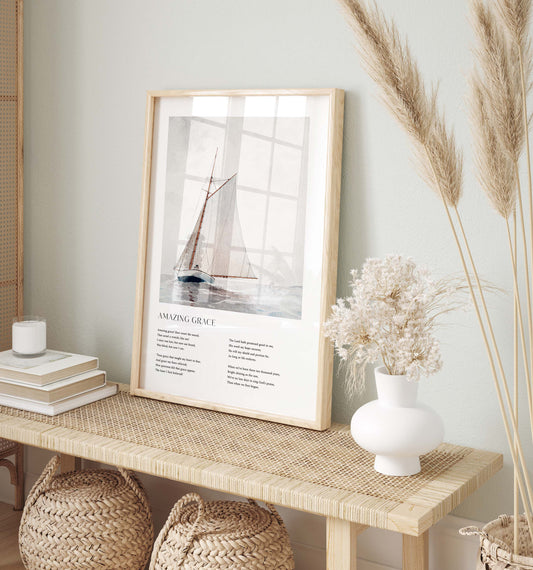 Framed Christian wall art print featuring a vintage-style illustration of a sailboat on the open sea. The artwork is paired with the timeless lyrics of "Amazing Grace," offering words of redemption and faith. This piece beautifully combines nautical imagery with spiritual reflection, making it an ideal addition to any home or prayer space.