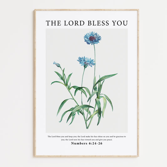 Framed wall art with a vintage floral illustration of blue cornflowers, paired with the Bible verse from Numbers 6:24-26: "The Lord bless you and keep you; the Lord make his face shine on you and be gracious to you; the Lord turn his face toward you and give you peace." The delicate floral art complements the serene message, making it perfect for both inspiration and decor.