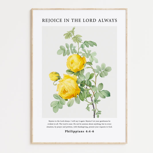 Vintage-style framed wall art showcasing an illustration of yellow roses, paired with the Bible verse from Philippians 4:4-6: "Rejoice in the Lord always. I will say it again: Rejoice! Let your gentleness be evident to all. The Lord is near. Do not be anxious about anything, but in every situation, by prayer and petition, with thanksgiving, present your requests to God." The artwork combines classic floral beauty with encouraging scripture for a serene and uplifting message.