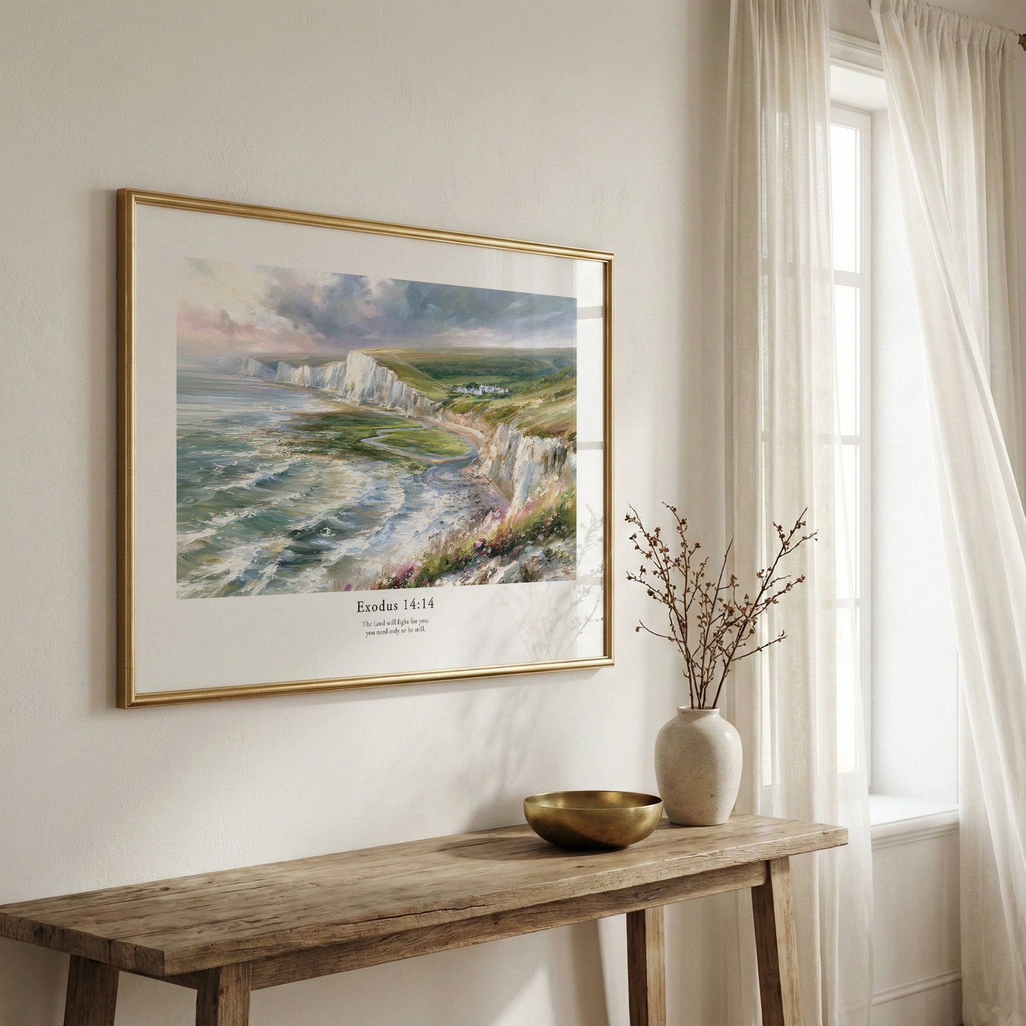 Framed scripture wall art with Exodus 14:14 and a dramatic coastal landscape, displayed above a rustic wooden bench.