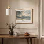 Framed scripture wall art with Psalm 19:1 and a luminous cloudy sky, displayed above a dining table in a neutral interior.