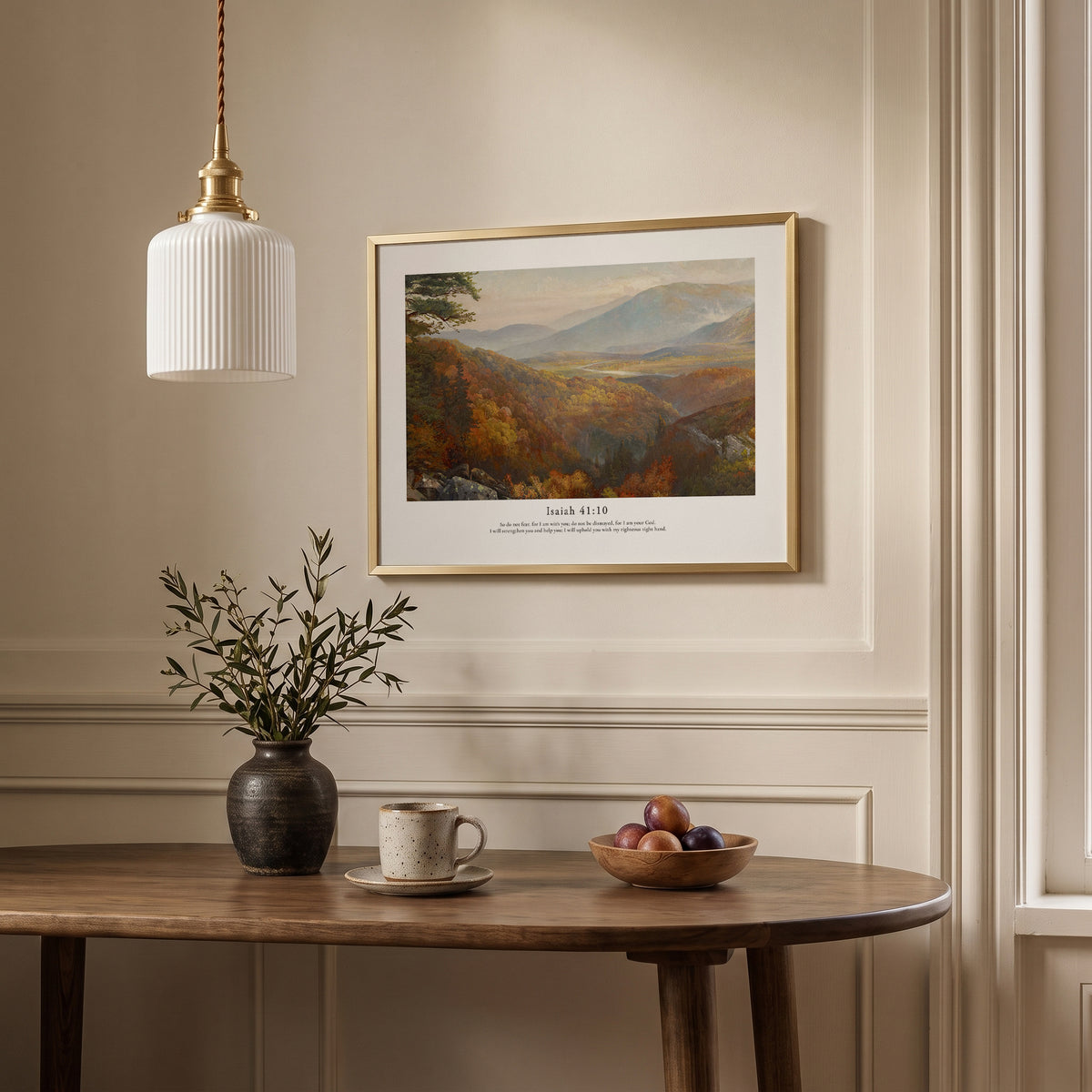 Isaiah 41:10 Bible verse wall art featuring a peaceful mountain scene, framed above a dining table in a neutral interior.