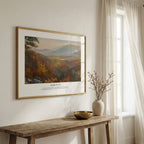 Framed scripture wall art with Isaiah 41:10 and an autumn mountain landscape, displayed above a rustic wooden bench.