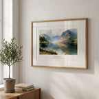 Christian wall art featuring Psalm 46:10 and a tranquil lake landscape, framed beside natural greenery.