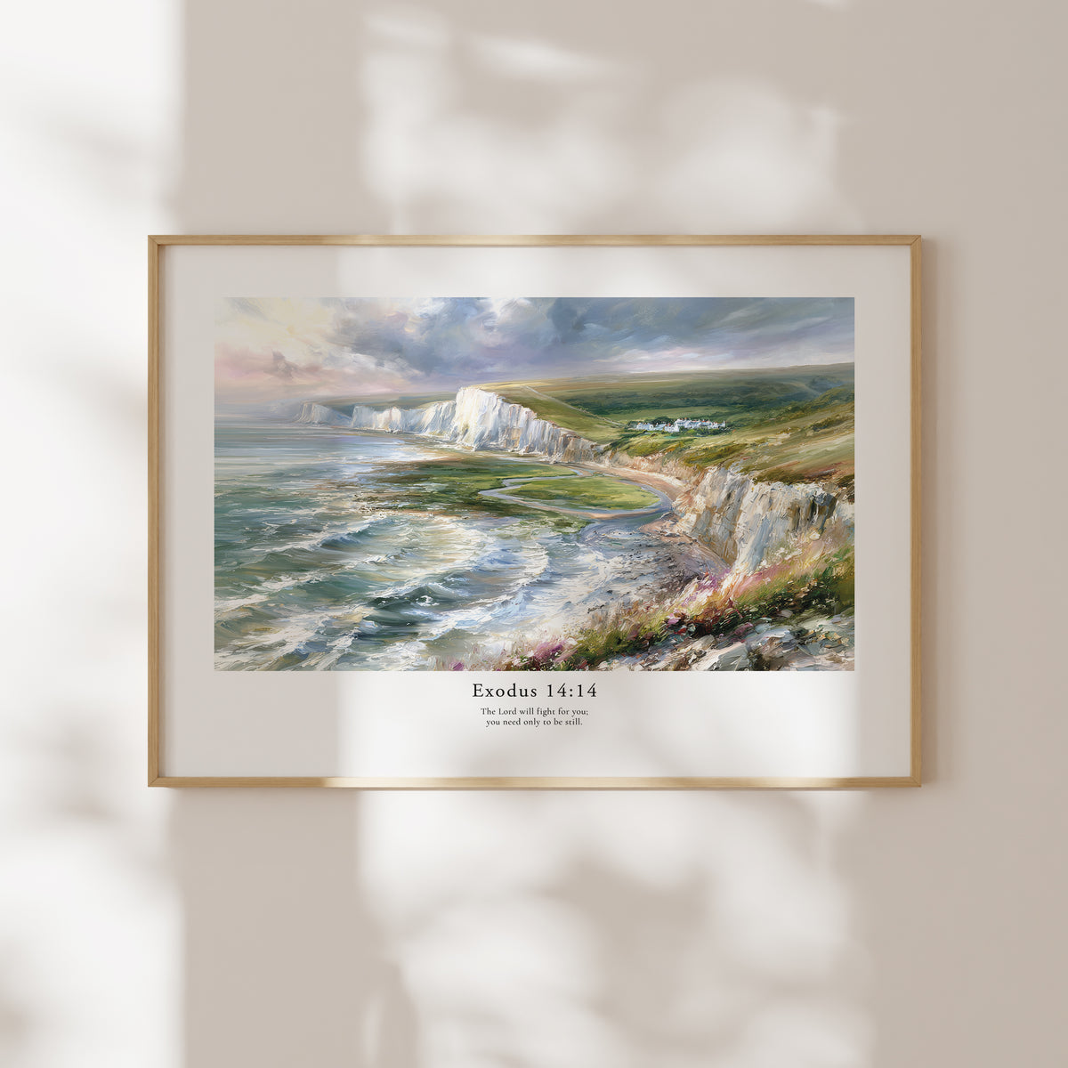 Framed Exodus 14:14 Bible verse wall art with a coastal cliff scene and soft natural window shadows.