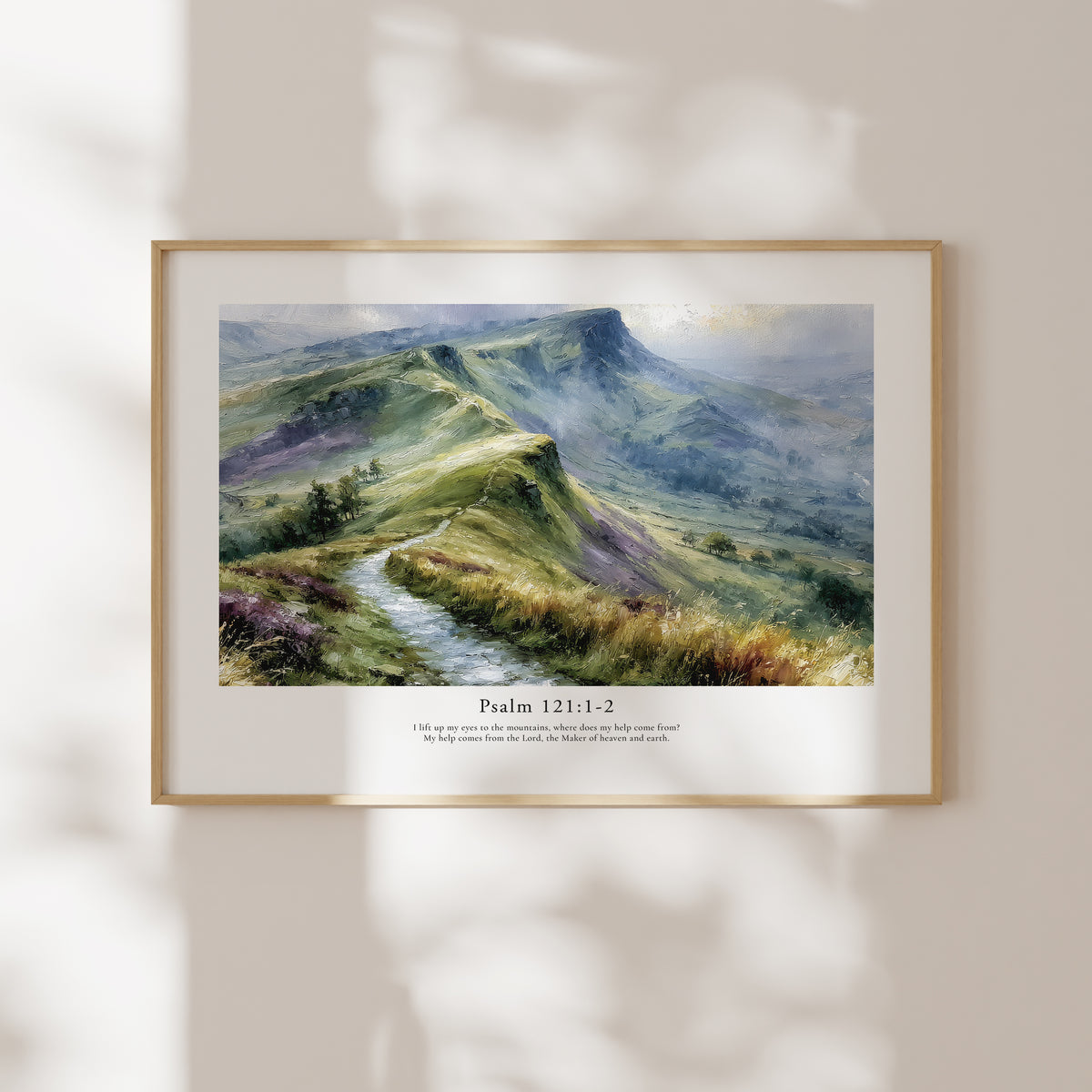 Framed Psalm 121:1–2 Bible verse wall art with a misty mountain scene and soft natural window shadows.