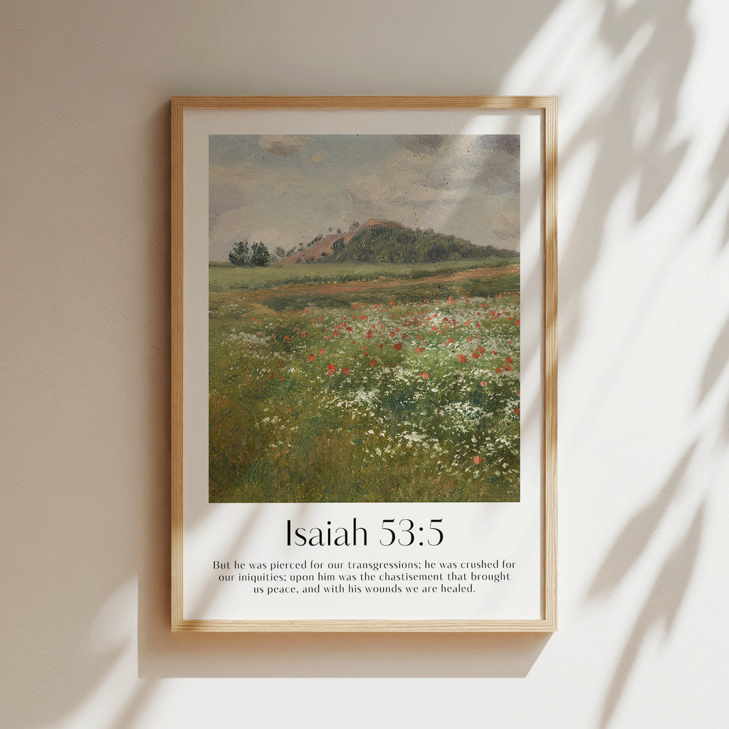 A framed Christian Print hanging on a wall with a vintage landscape and the bible verse Isaiah 53:5