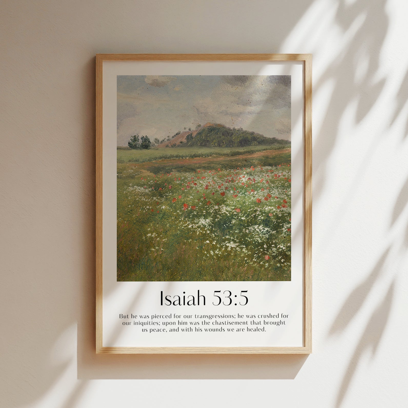 A framed Christian Print hanging on a wall with a vintage landscape and the bible verse Isaiah 53:5