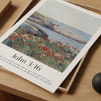 A close up of a framed Christian Print with a vintage seascape and the bible verse John 3:16