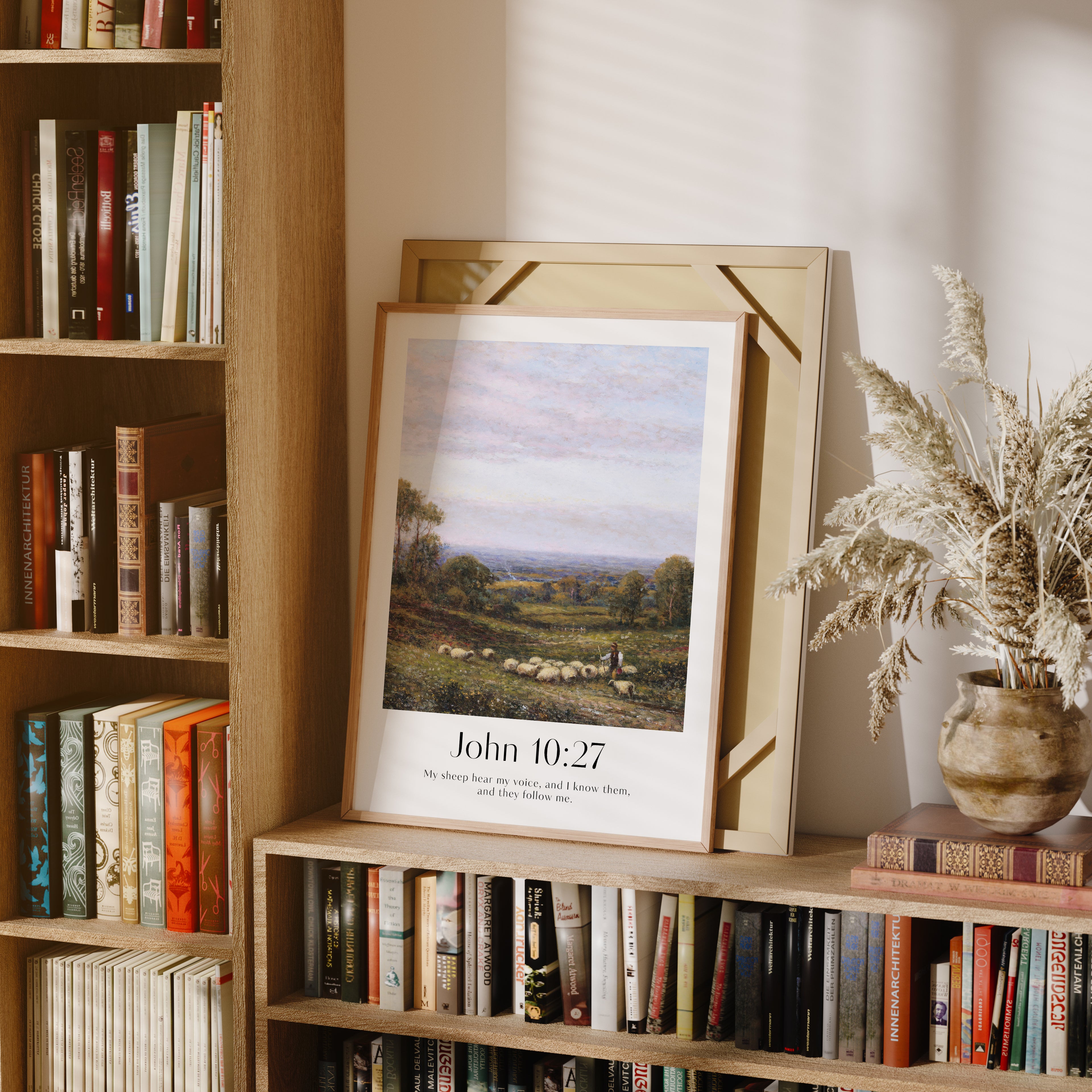 A framed Christian Print on a bookcase for Easter with a vintage landscape and the bible verse John 10:27 My sheep hear my voice