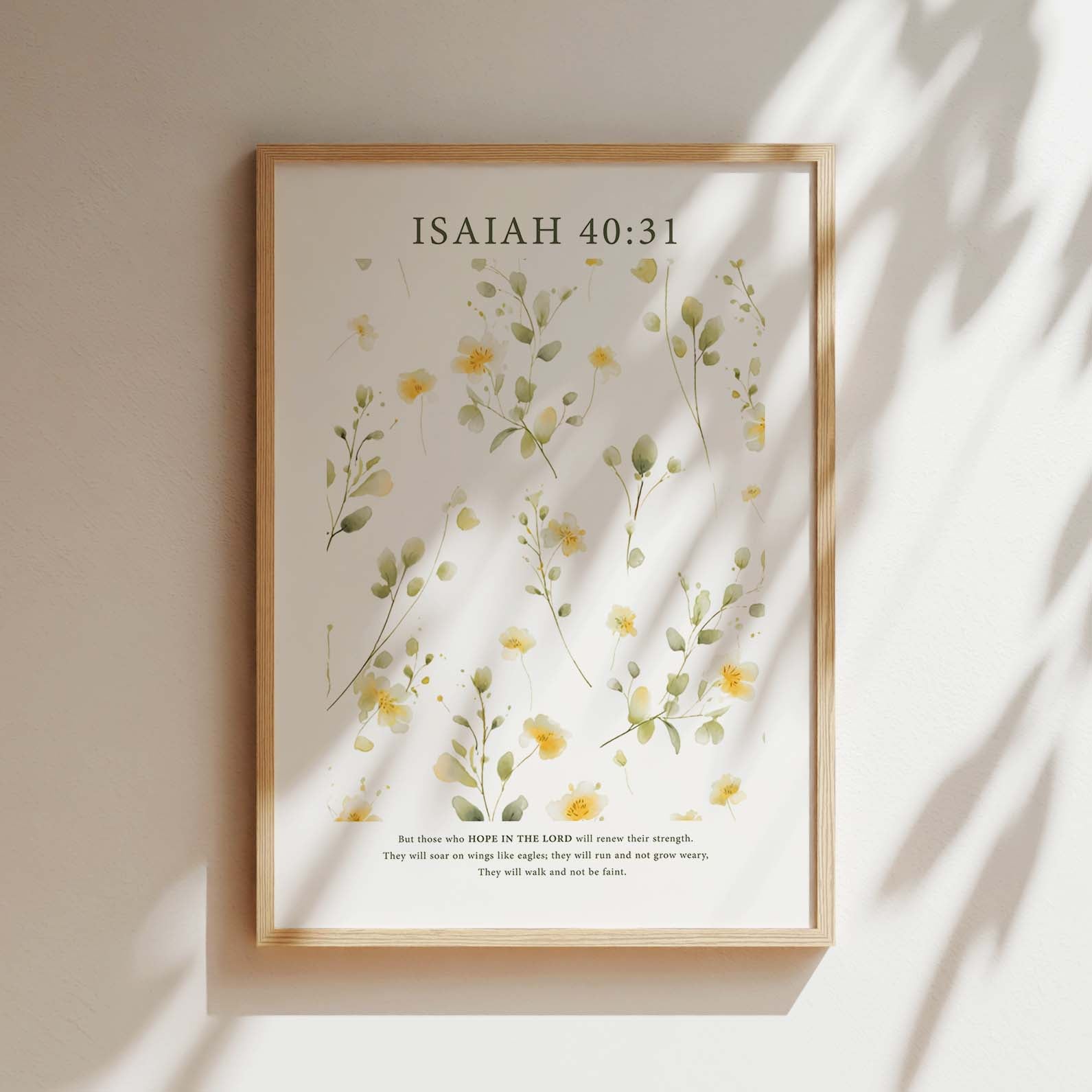 Framed Christian wall art print featuring a delicate botanical illustration of soft yellow flowers. The artwork is paired with the Bible verse Isaiah 40:31: "But those who hope in the Lord will renew their strength. They will soar on wings like eagles; they will run and not grow weary, they will walk and not be faint." This serene piece brings nature and scripture together, making it an ideal addition to any home or prayer space.