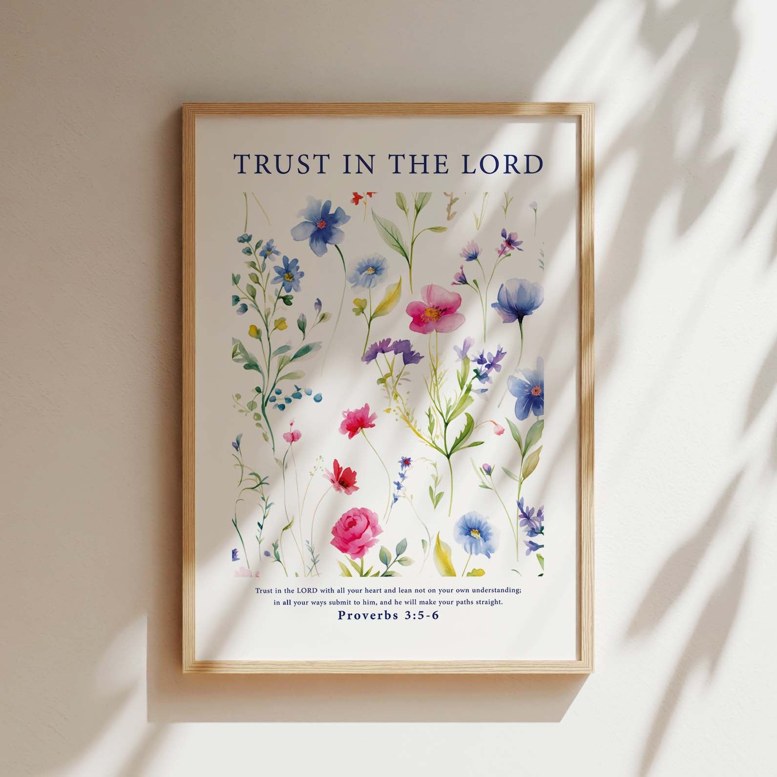 Framed Christian wall art print featuring a vibrant botanical illustration of various colorful flowers. The artwork is accompanied by the Bible verse Proverbs 3:5-6: "Trust in the Lord with all your heart and lean not on your own understanding; in all your ways submit to him, and he will make your paths straight." This piece provides a harmonious combination of floral beauty and spiritual encouragement, perfect for any home or prayer space.