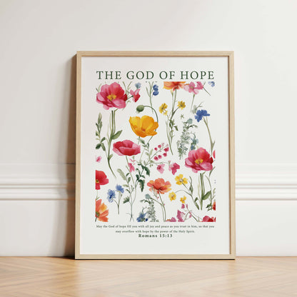 Framed Christian wall art print featuring a beautiful botanical illustration with vibrant flowers. The artwork is paired with the Bible verse from Romans 15:13: "May the God of hope fill you with all joy and peace as you trust in him, so that you may overflow with hope by the power of the Holy Spirit." This piece combines nature's beauty with an uplifting message, making it a perfect addition to any home or prayer space.