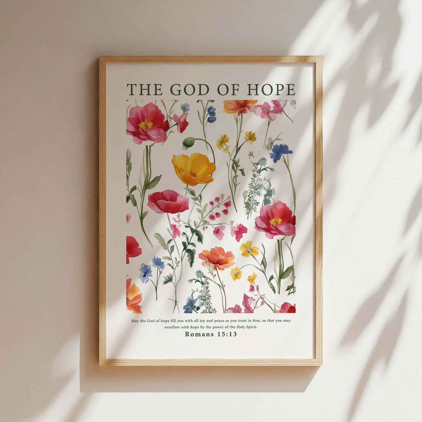 Framed Christian wall art print featuring a beautiful botanical illustration with vibrant flowers. The artwork is paired with the Bible verse from Romans 15:13: "May the God of hope fill you with all joy and peace as you trust in him, so that you may overflow with hope by the power of the Holy Spirit." This piece combines nature's beauty with an uplifting message, making it a perfect addition to any home or prayer space.