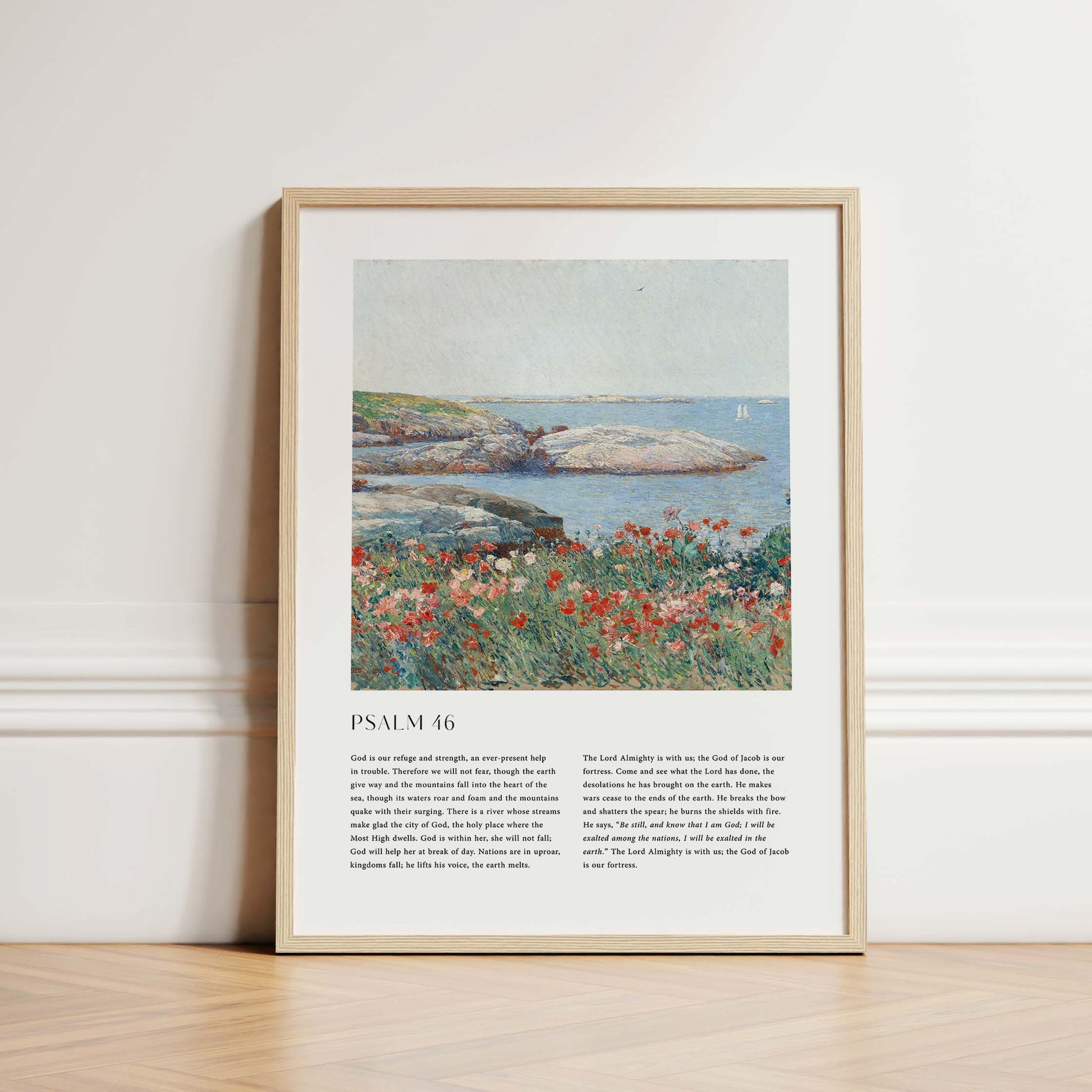 Framed Christian wall art print featuring a serene coastal landscape inspired by Childe Hassam. The artwork pairs a vivid depiction of a rocky shoreline and blossoming wildflowers with the full text of Psalm 46, emphasizing God’s refuge and strength. This piece harmonizes natural beauty with spiritual comfort, making it a perfect addition to any home or place of worship.