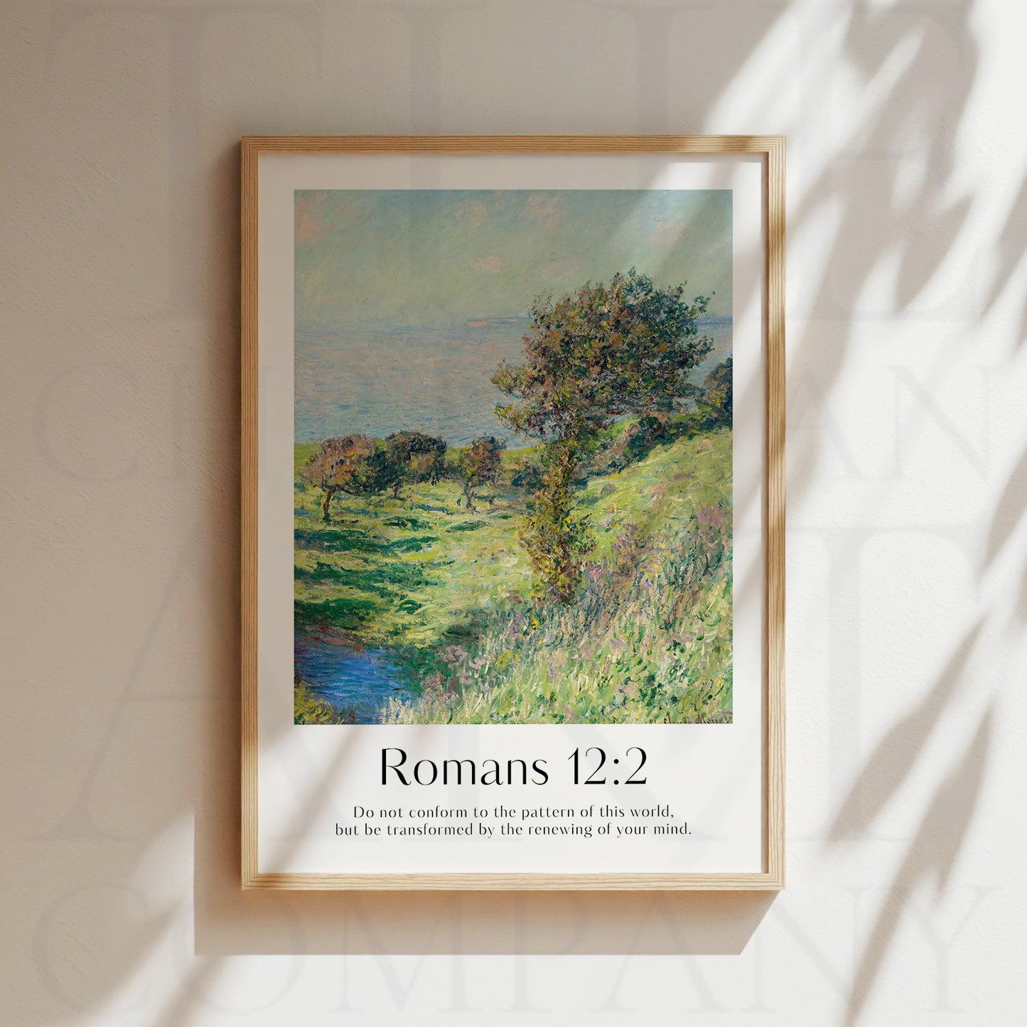 Framed Christian wall art print with a landscape inspired by Claude Monet. The scene features a peaceful grassy hill with trees, overlooking a distant body of water, paired with the Bible verse Romans 12:2: "Do not conform to the pattern of this world, but be transformed by the renewing of your mind." This print combines nature's beauty with an inspiring message of personal and spiritual growth, perfect for home decor.