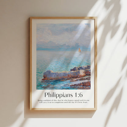 Framed Christian wall art print featuring a serene coastal scene inspired by Menci Clement. The artwork depicts a tranquil ocean view with a distant sailboat, paired with the Bible verse Philippians 1:6: "Being confident of this, that he who began a good work in you will carry it on to completion until the day of Christ Jesus." This piece beautifully combines peaceful scenery with spiritual encouragement, making it a thoughtful addition to any home or prayer space.