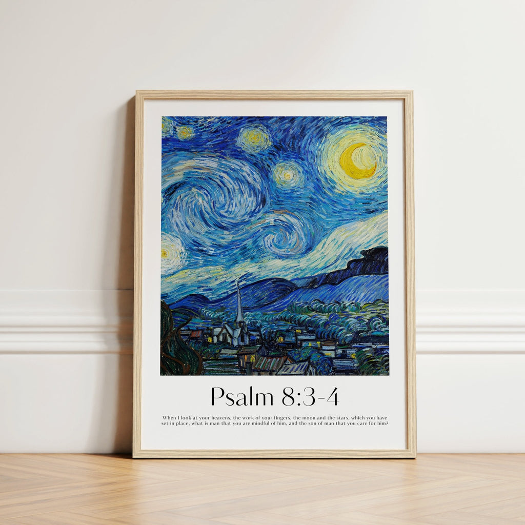 A framed art print of a stylized Starry Night-inspired landscape with the text 'Psalm 8:3-4' and a short Bible verse below, leaning against a white wall on a light wood floor.