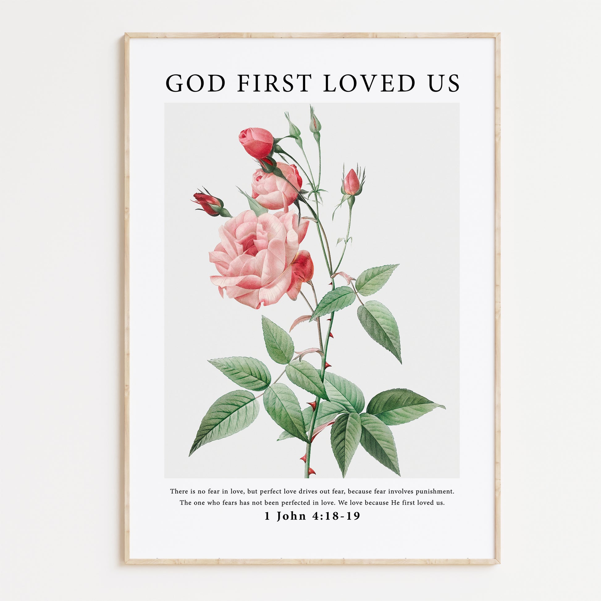 Vintage-style framed wall art showcasing an illustration of flowers with the ‘god first loved us’ bible verse for Christian Home Decor