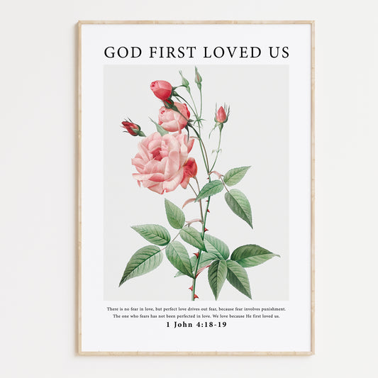 Vintage-style framed wall art showcasing an illustration of flowers with the ‘god first loved us’ bible verse for Christian Home Decor