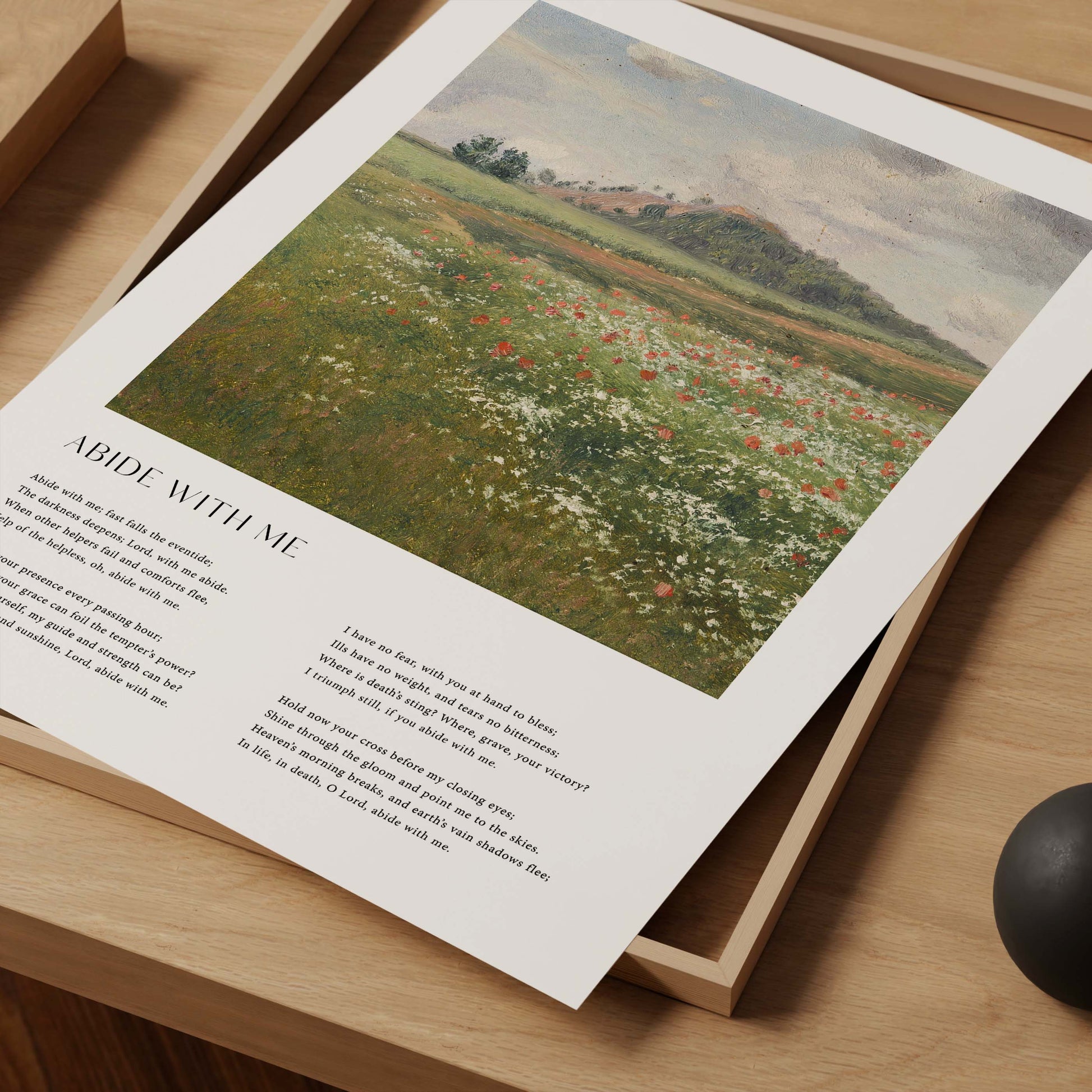 Framed Christian wall art print featuring a vintage-style landscape of a peaceful meadow filled with wildflowers. The artwork is paired with the comforting lyrics of the hymn "Abide With Me," offering words of solace and divine presence. This piece combines serene natural beauty with spiritual reflection, making it an ideal addition to any home or prayer space.