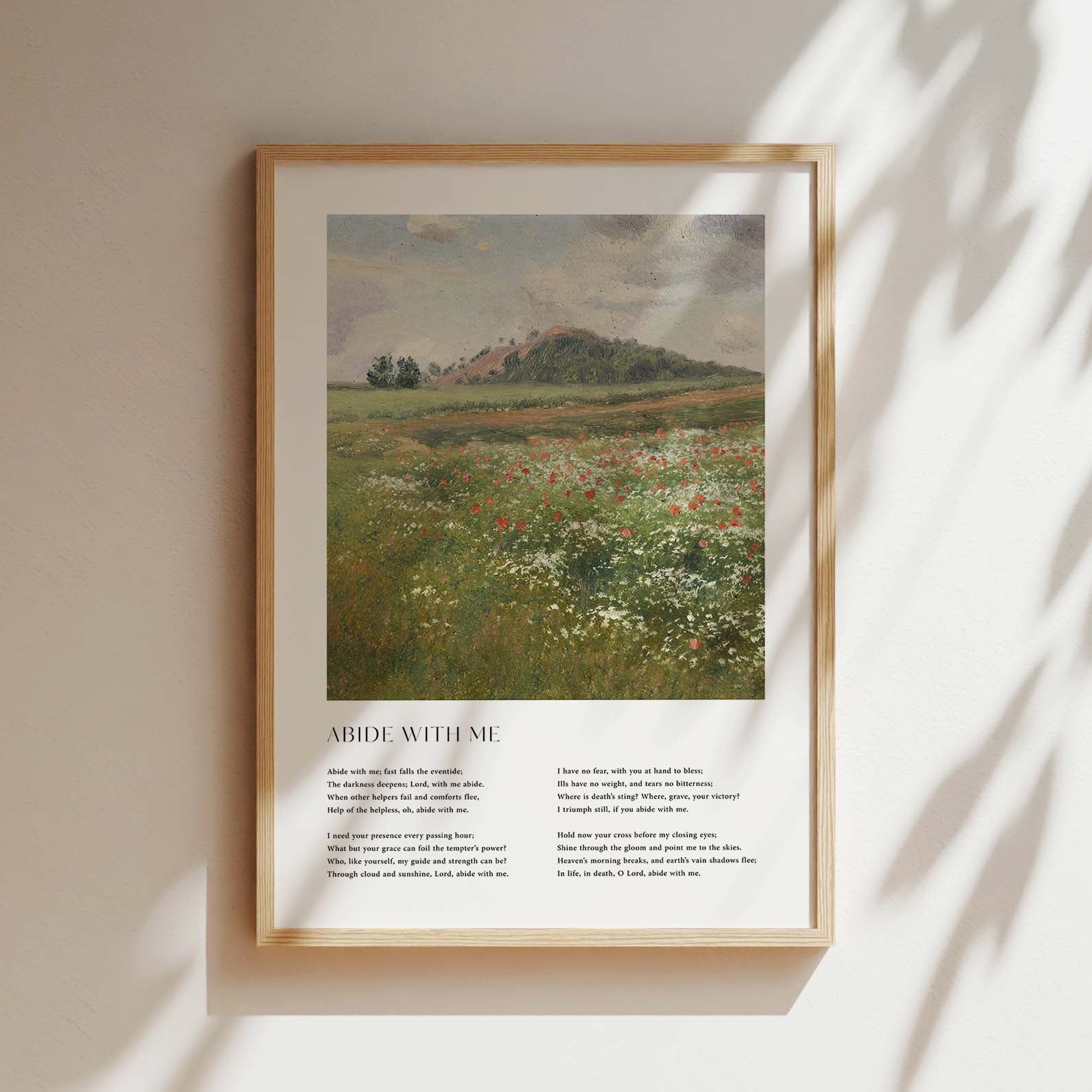 Framed Christian wall art print featuring a vintage-style landscape of a peaceful meadow filled with wildflowers. The artwork is paired with the comforting lyrics of the hymn "Abide With Me," offering words of solace and divine presence. This piece combines serene natural beauty with spiritual reflection, making it an ideal addition to any home or prayer space.