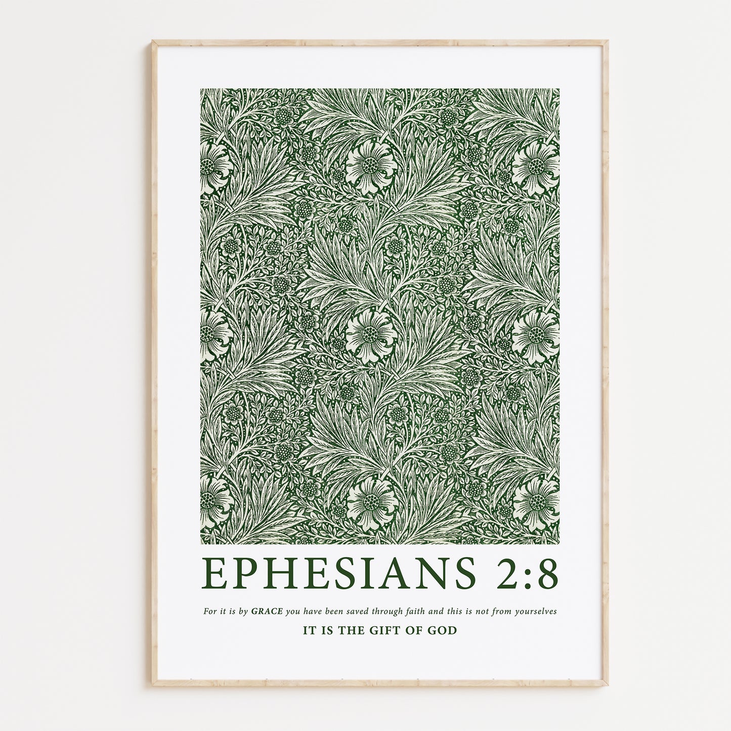 Framed Christian wall art print featuring a green botanical pattern by William Morris. Displays the Bible verse Ephesians 2:8: "For it is by grace you have been saved through faith and this is not from yourselves, it is the gift of God." This artwork blends classic, nature-inspired design with powerful scripture, making it a meaningful addition to any Christian home. Elegantly framed in light wood, ideal for enhancing living room or prayer space decor.